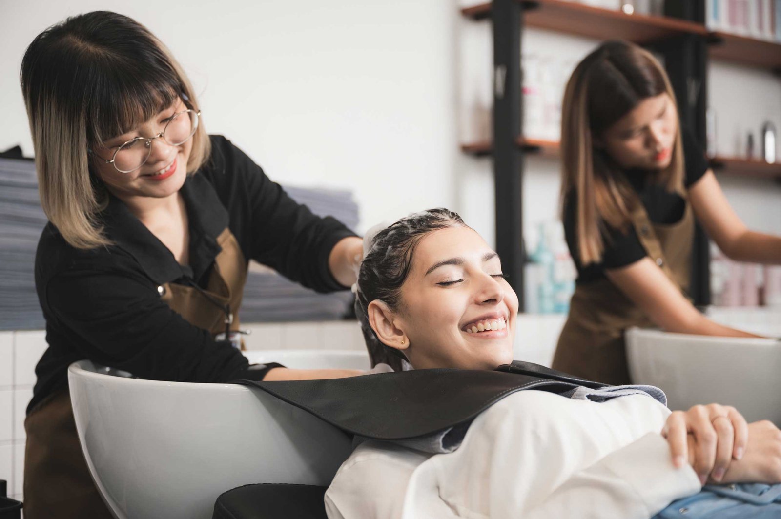 hairdresser washing client s hair at salon happy 2025 03 24 11 26 34 utc.jpg